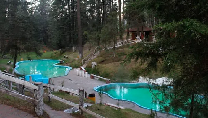 Steam rising from sulfur-rich thermal water at Los Azufres