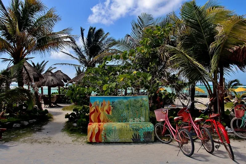 Rental bicycles parked near the sandy streets of Mahahual