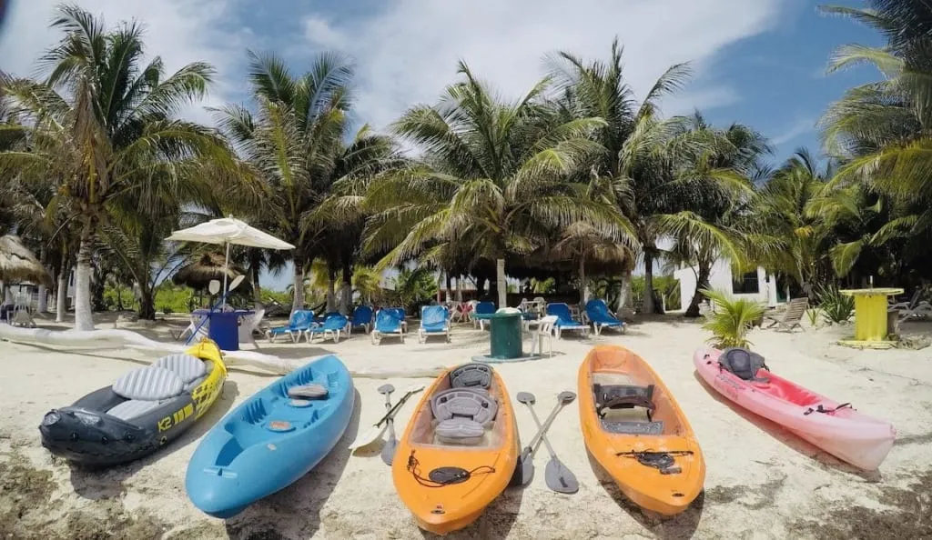 Single kayak floating over clear water near Mahahual shore