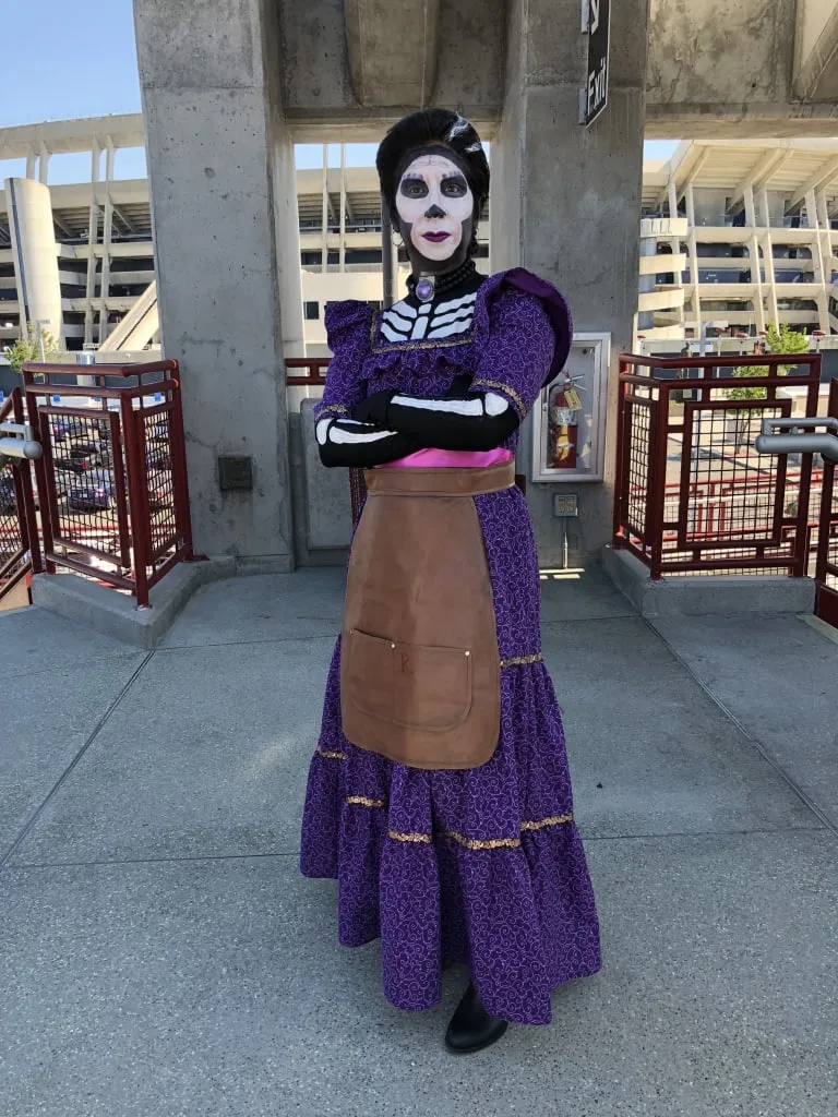 Mama Imelda Coco costume with purple dress shawl and braided hair