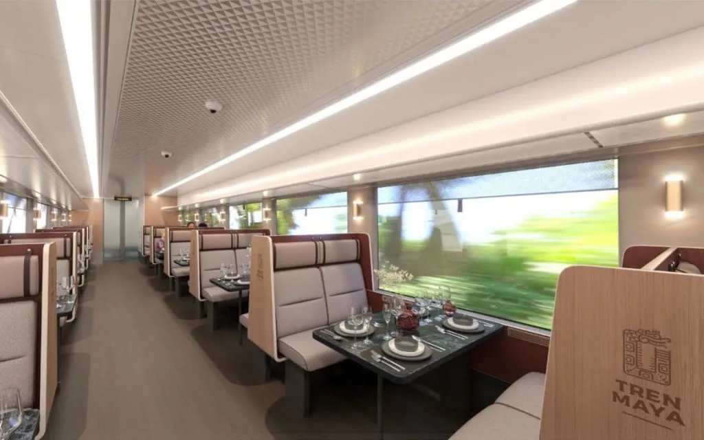 Passenger seats and wide windows inside a Tren Maya rail car