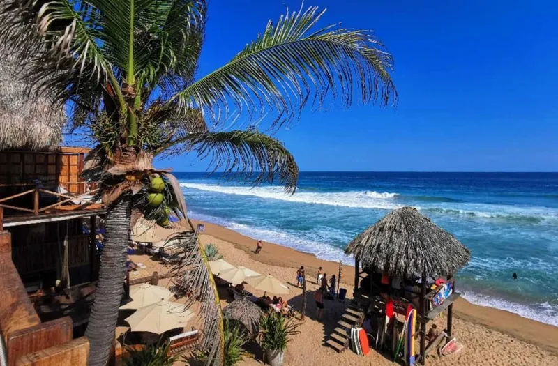 Mazunte beach in March with dry-season sun, Pacific surf, and small-town Oaxaca Coast pacing
