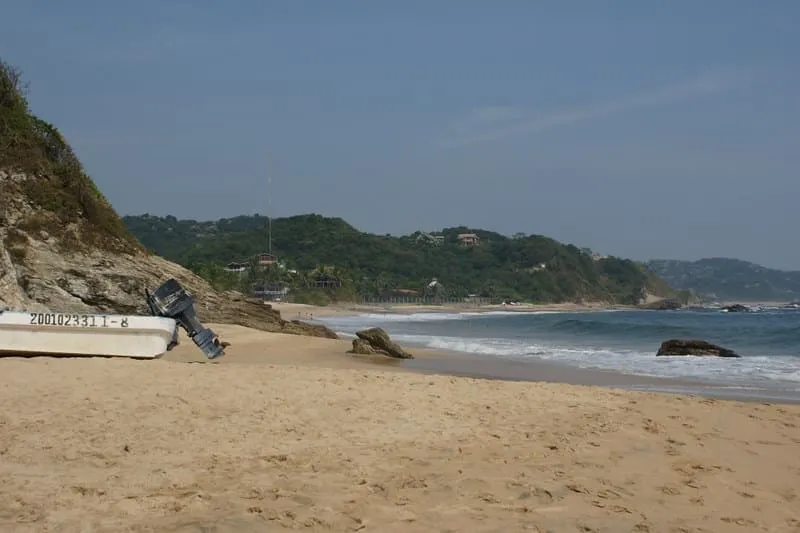 Sandy Mazunte village lane with simple guesthouses during humid August beach weather