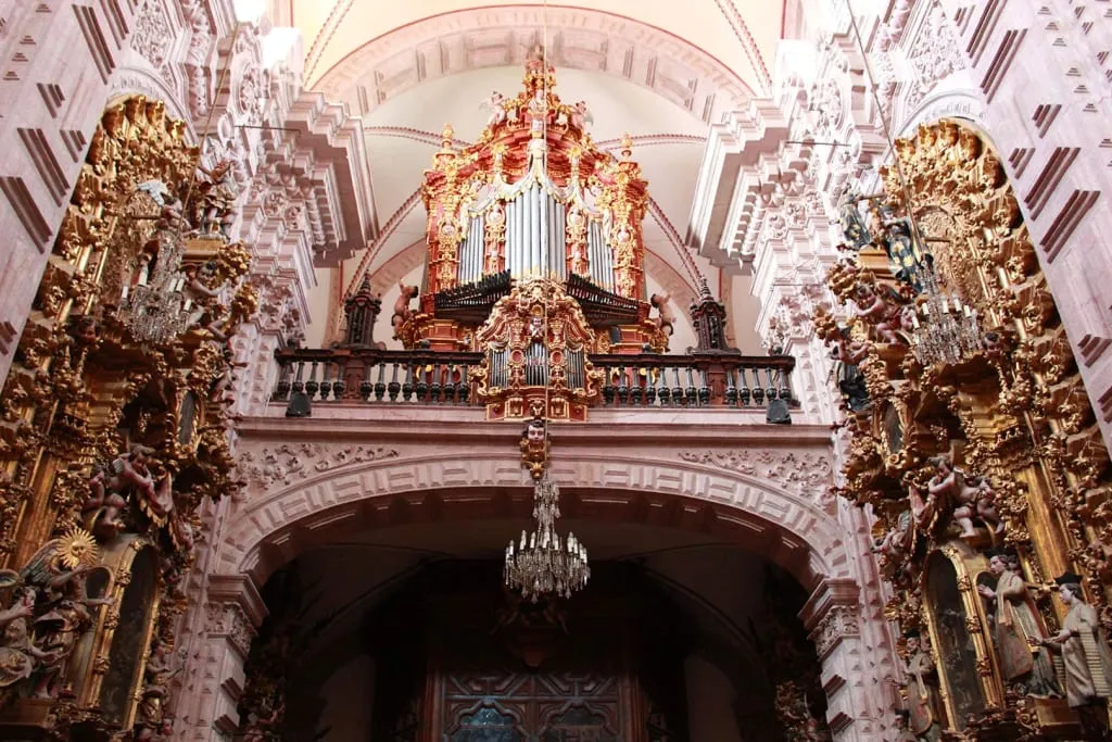 Santa Prisca Cathedral in Taxco Guerrero illuminated at night with crowds during Semana Santa Holy Week processions