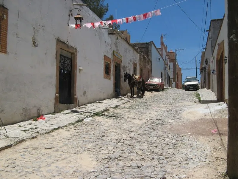 Quiet Mineral de Pozos street lined with restored colonial facades