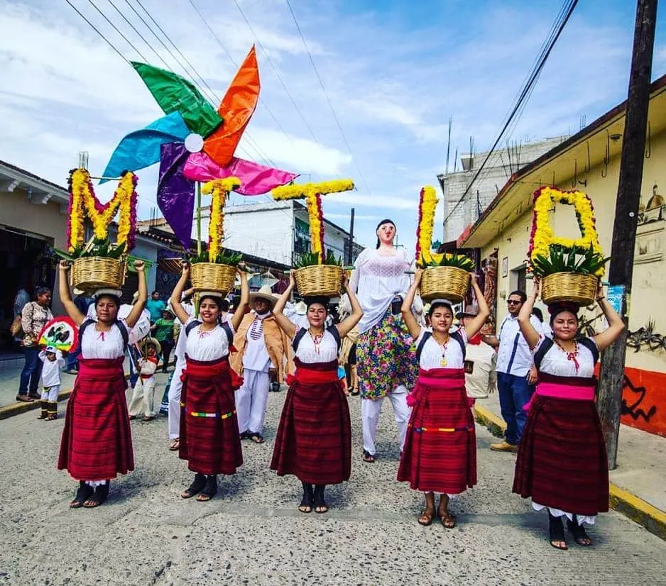 San Pablo festival procession with music and traditional figures in Mitla