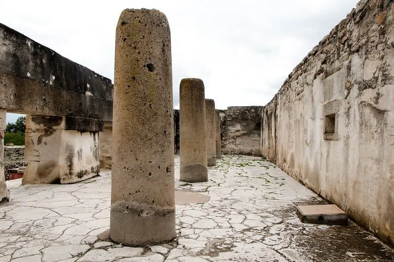 Open courtyard surrounded by low stone structures at the Mitla ruins