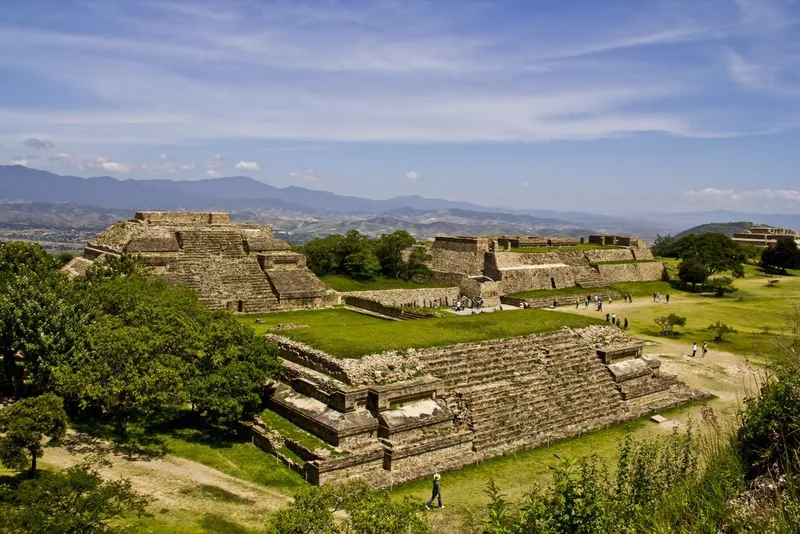 Monte Albán Zapotec archaeological zone with the Great Plaza, pyramid platforms, and Ball Court spread across a flattened hilltop above the Valley of Oaxaca