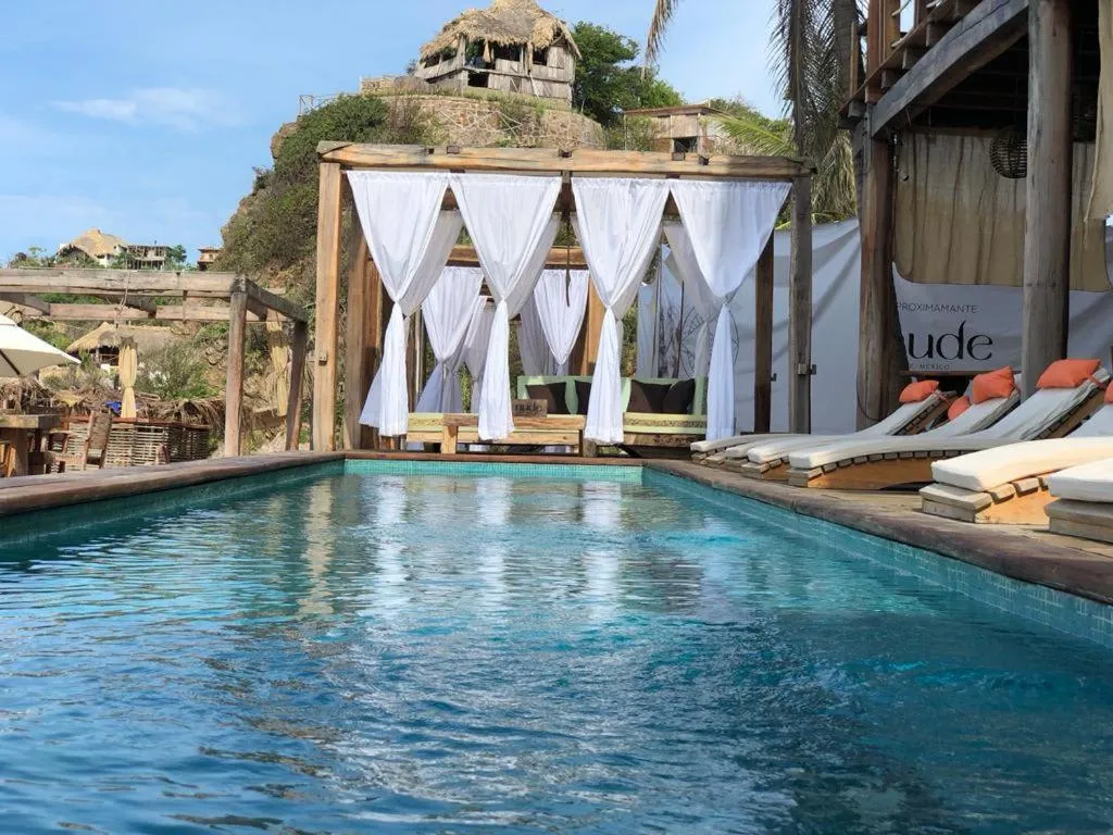 Hotel Nude Zipolite pool and beach club area at Zipolite beach, Oaxaca