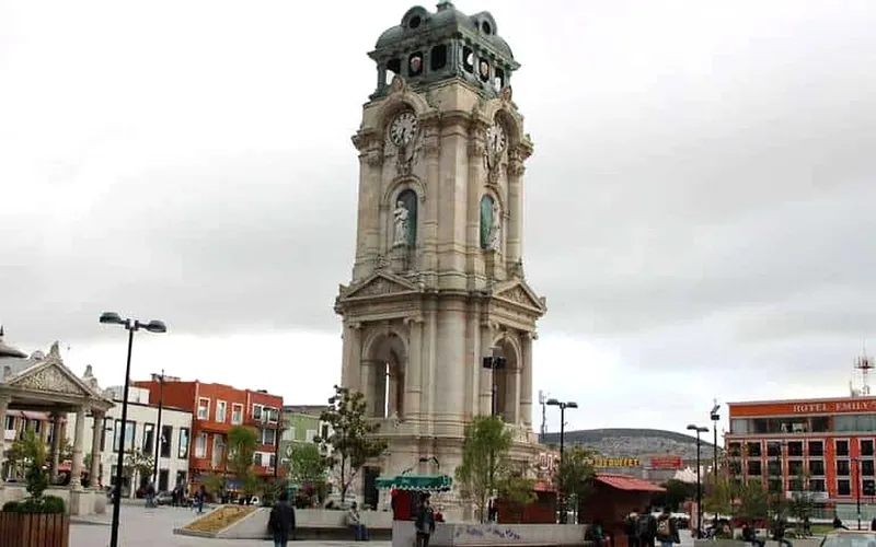 Pachuca clock tower and central plaza during August rainy-season weather in Hidalgo