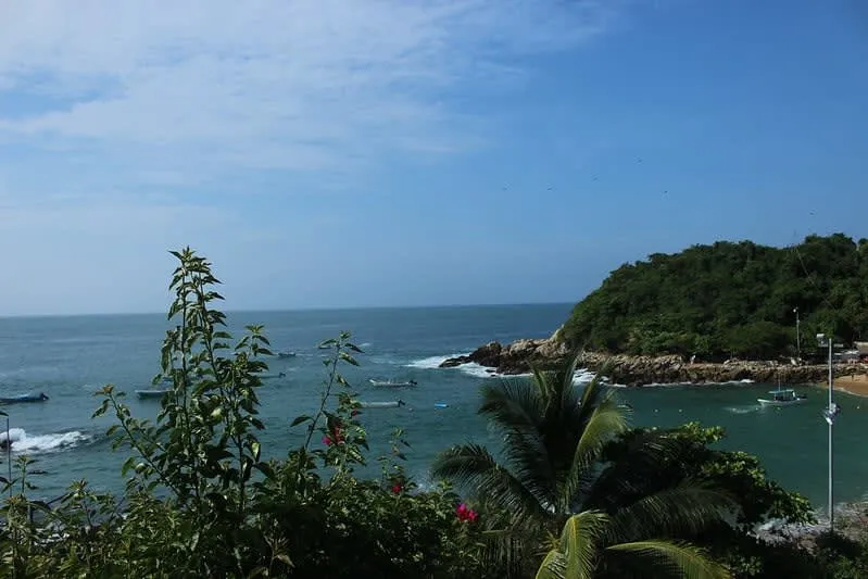 Calm Puerto Angelito bay with fishing boats near shore
