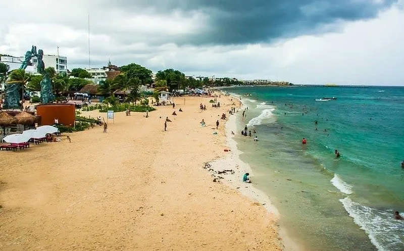 Clear Caribbean water washing onto the sandy Playa del Carmen beachfront
