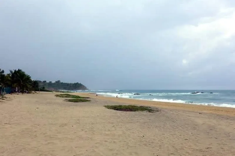 Wide Puerto Escondido beach under clear January sun with Pacific waves rolling toward the Oaxaca coast