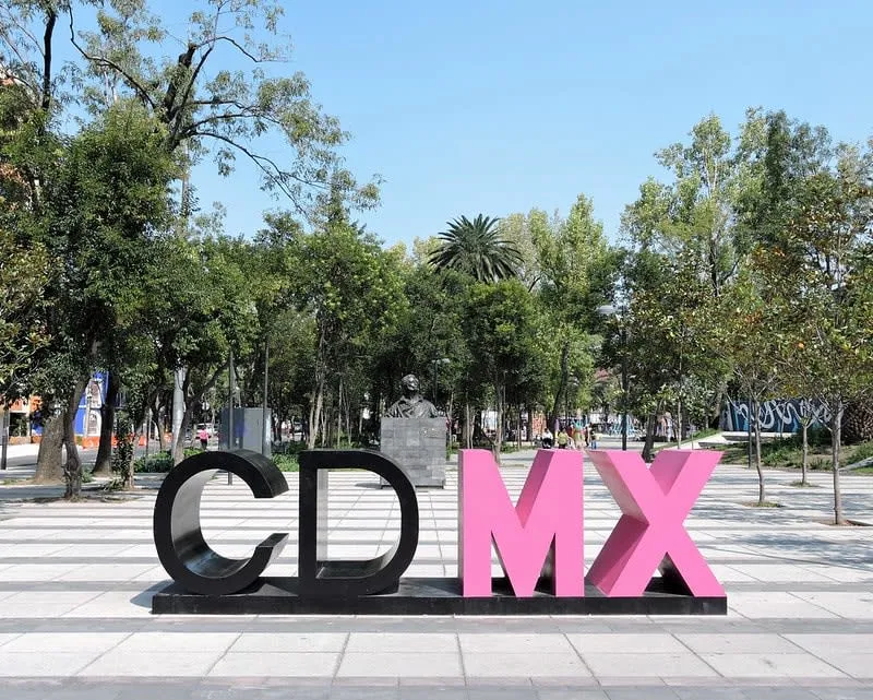 La Romita plaza with leafy paths and old neighborhood buildings