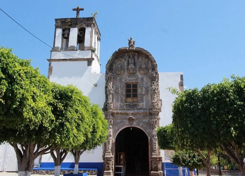 Nativitas Parish Church with a small plaza in front of its stone entrance