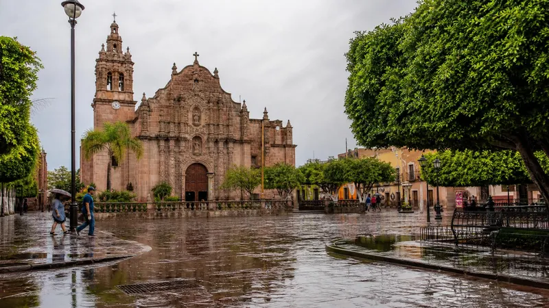 Salamanca church facade and wet plaza after June rain in Guanajuato