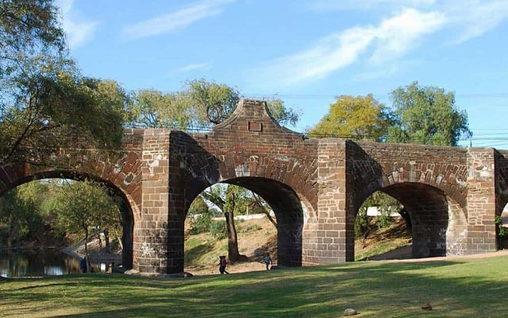 Colonial bridge and waterway in San Juan del Río, Querétaro — the first major town on MEX-57D from Mexico City, an hour south of Querétaro city