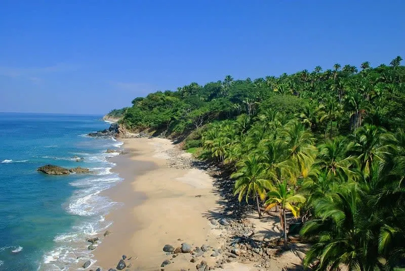 Wide San Pancho beach in February with dry sand, Pacific surf, and a relaxed Nayarit coast mood