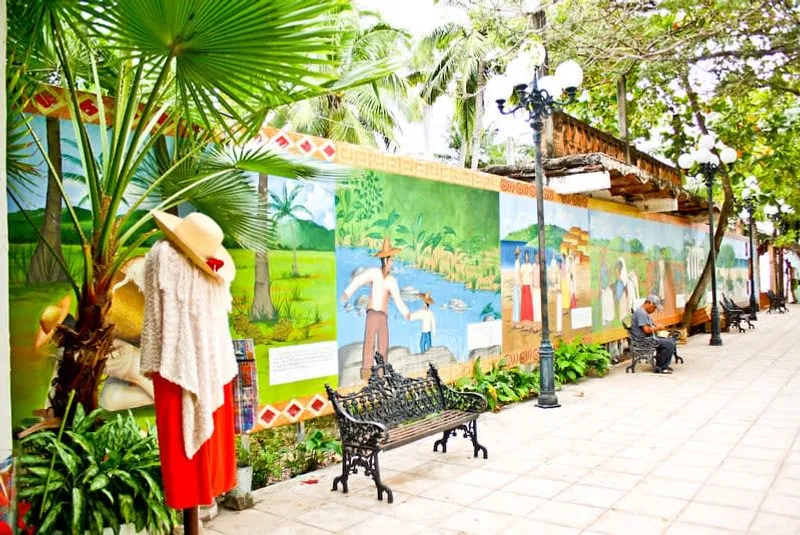 San Pancho town street in February with dry-season weather, palm trees, and colorful low buildings