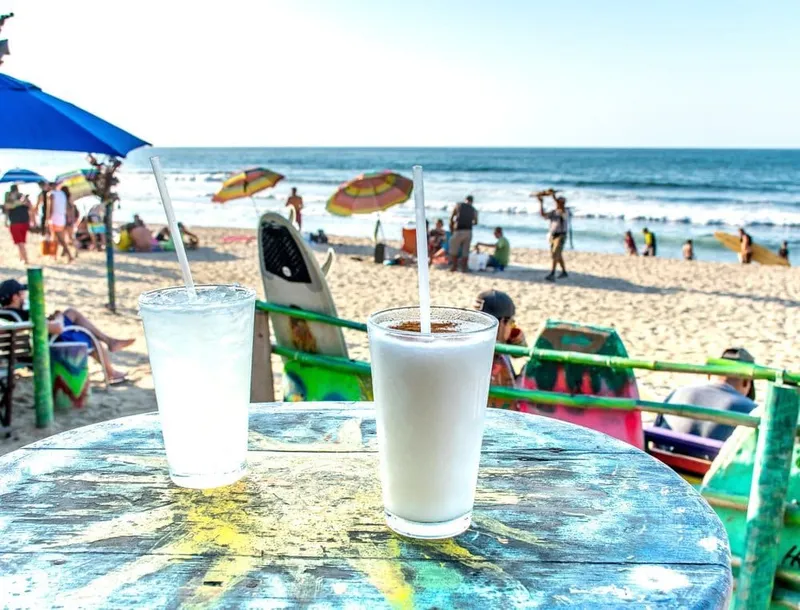 Surfers and swimmers sharing the main beach in Sayulita on a sunny dry-season day