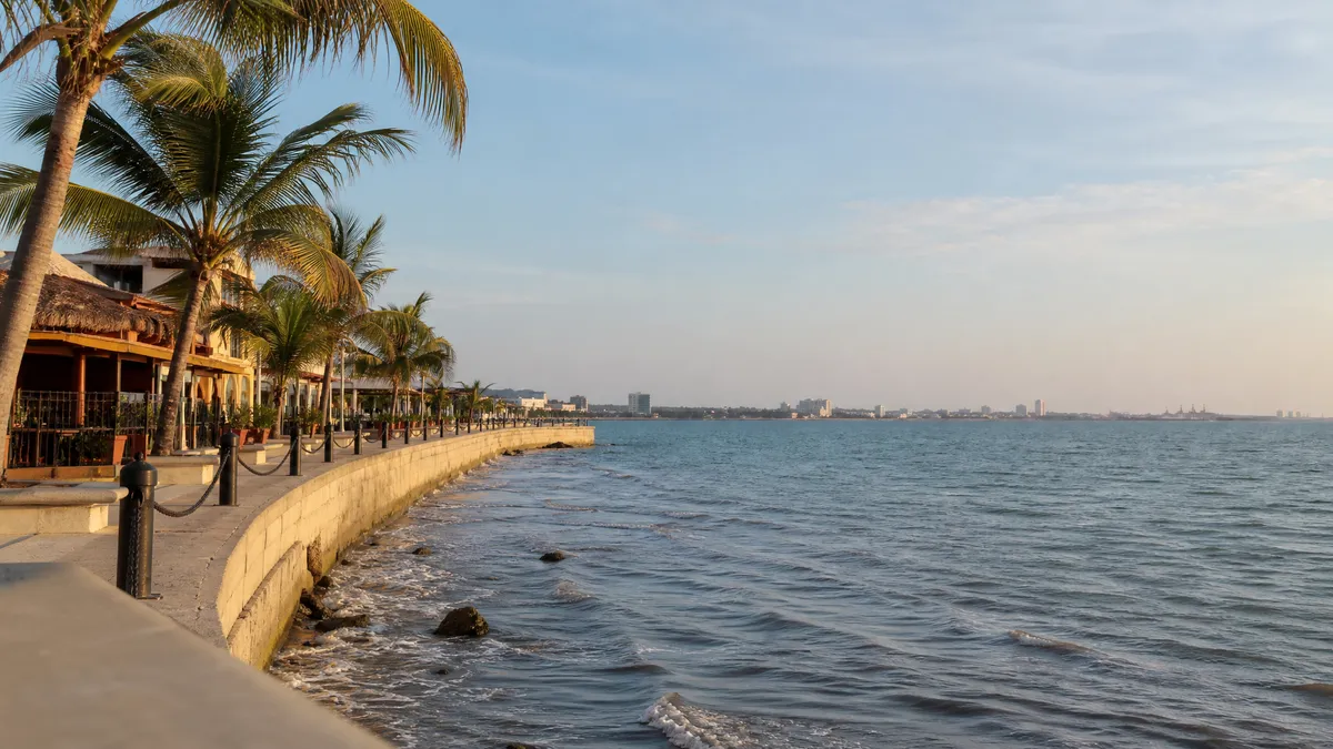 Tampico waterfront with palm trees, open walkways, and soft winter sun over the Gulf Coast