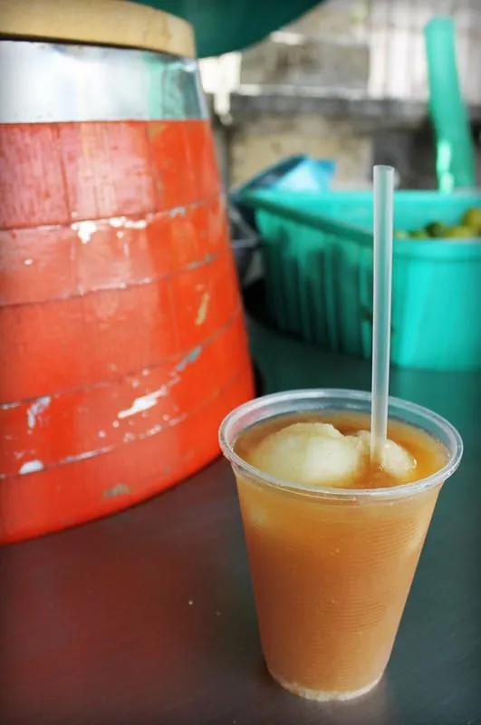 Clay cup of tejuino shown for comparison with pineapple tepache
