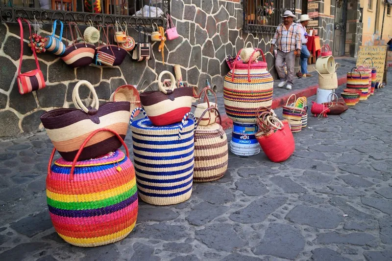Plates of market food in Tepoztlán served near colorful stalls and woven baskets