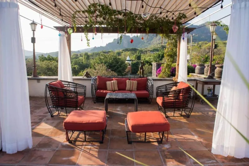 Garden hotel courtyard in Tepoztlán with palms, stone paths, and mountain air