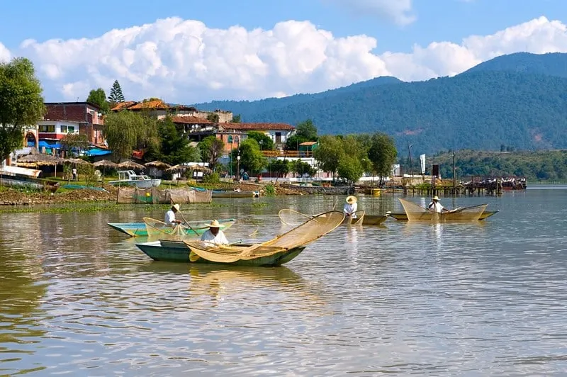 Lake Pátzcuaro in August with green rainy-season hills, cool highland air, and morning boat-trip planning