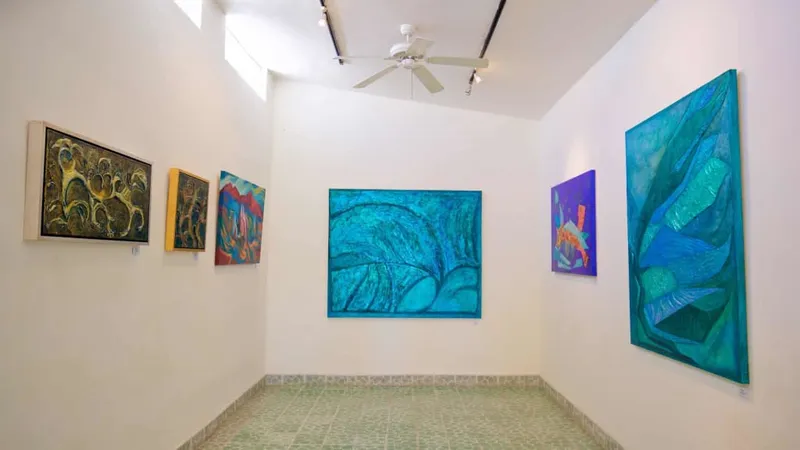 Art galleries with colorful facades and sculptures on the cobblestone main street of Todos Santos, Baja California Sur, a UNESCO-designated Pueblo Mágico