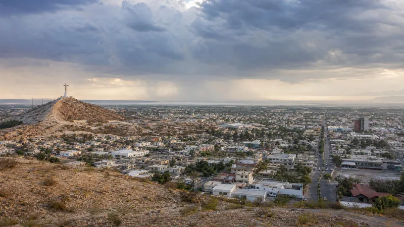 August storm-season desert view over Torreon with Cristo de las Noas and La Laguna city light