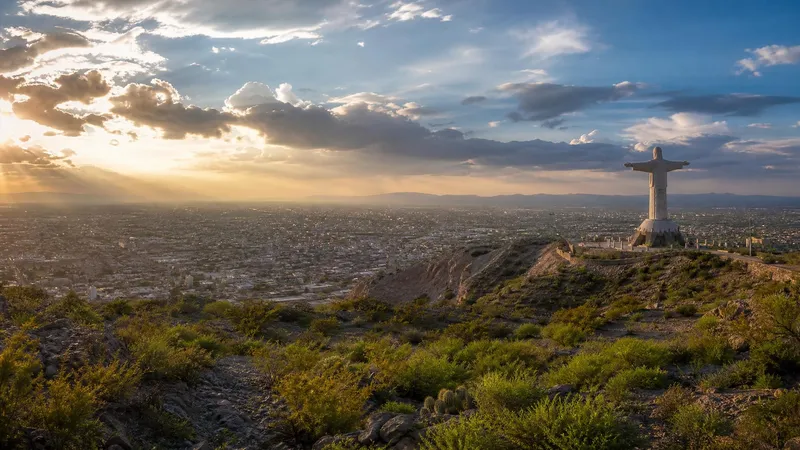 September desert city view over Torreon with Cristo de las Noas and late rainy-season clouds