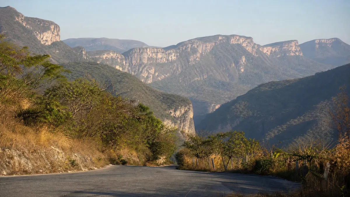 Sunlit hills and a clear road through lowland Chiapas after the winter rains