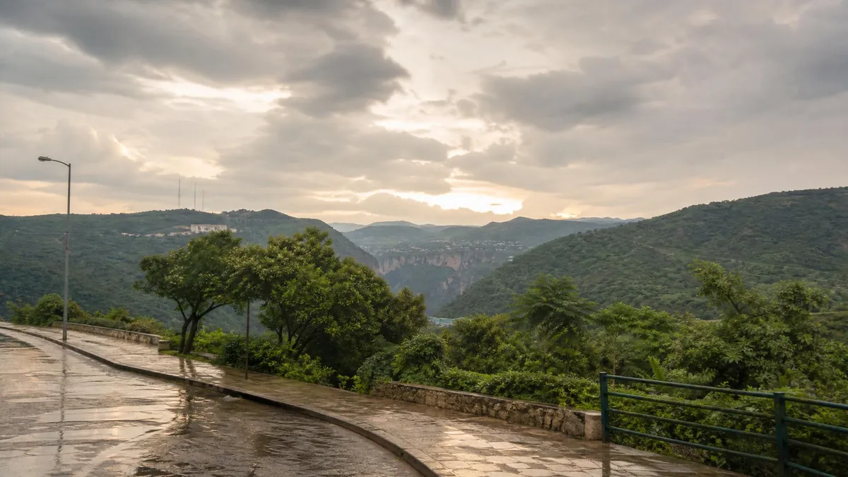 Wet road and green hills near Tuxtla Gutierrez after a September rainy-season shower