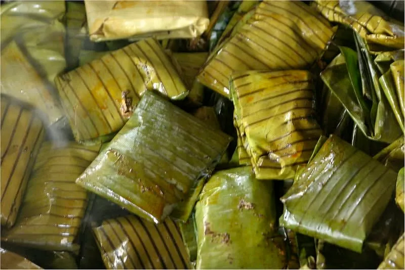 Oaxacan tamales folded in glossy banana leaves