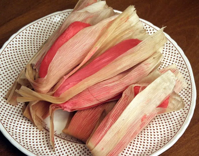 Pink sweet tamales de dulce in corn husks