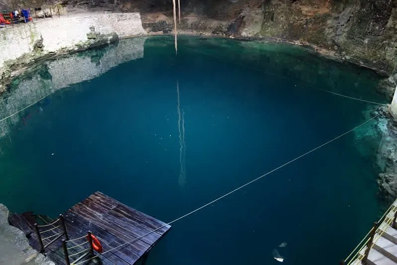 Cave cenote near Valladolid Yucatán with light beam through natural opening
