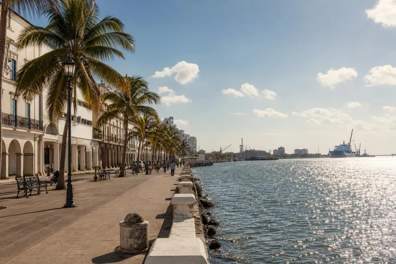 Malecon promenade beside the Gulf under dry-season blue sky