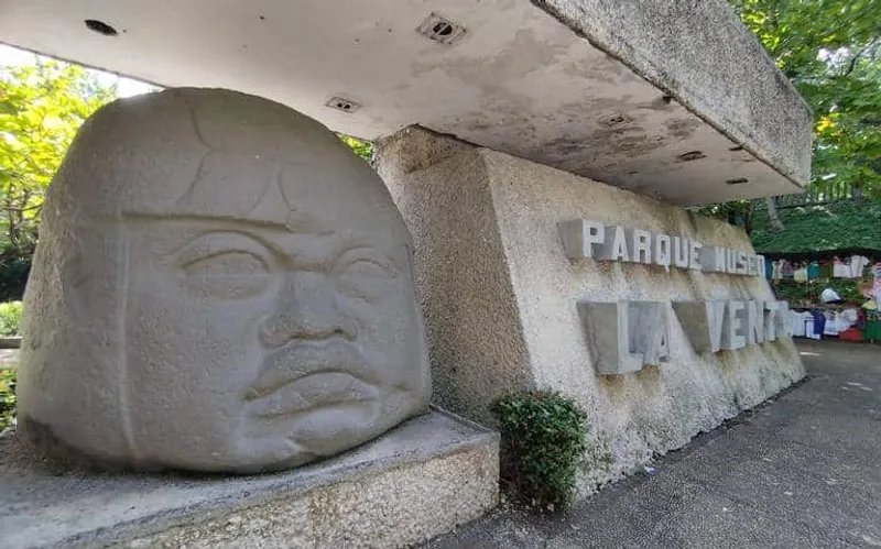Olmec head sculpture beside the entrance wall at La Venta Museum Park