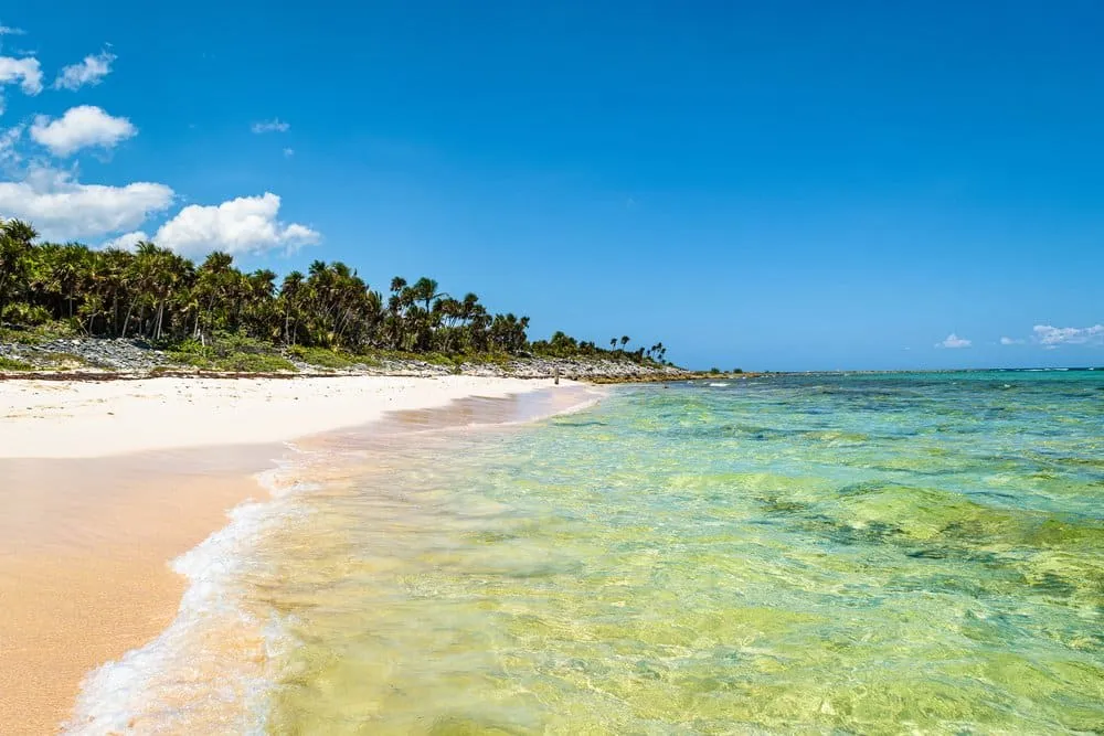 Quiet white-sand shoreline at Xcacel with turquoise Caribbean water