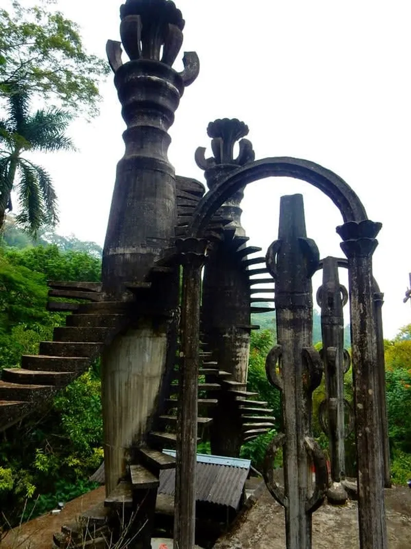 Misty green Xilitla hills and Las Pozas garden structures above the Huasteca route