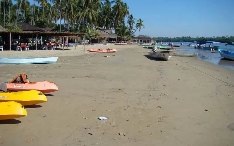 Playa La Ropa bay in Zihuatanejo with green rainy-season hills and Pacific water