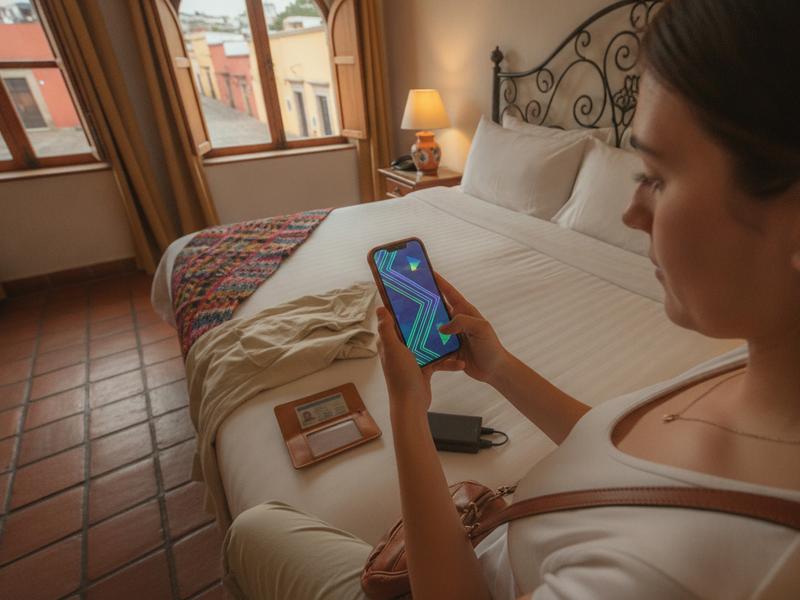Traveler checking a valid digital Cervantino ticket before leaving a Guanajuato hotel