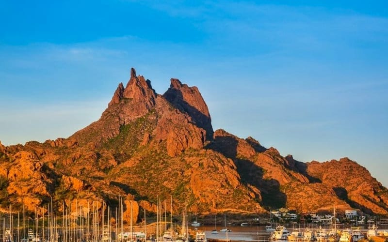 Rocky coastline near Guaymas and San Carlos under August sun and late-summer clouds
