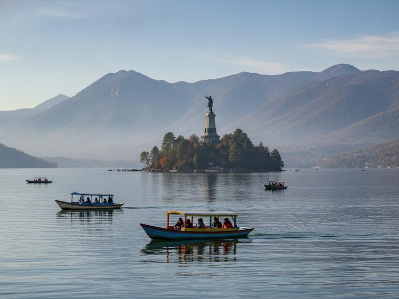 Janitzio island and passenger boats in clear November daylight on Lake Pátzcuaro