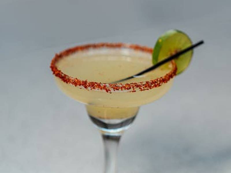 Classic Mexican margarita cocktail with salt rim and lime wedge