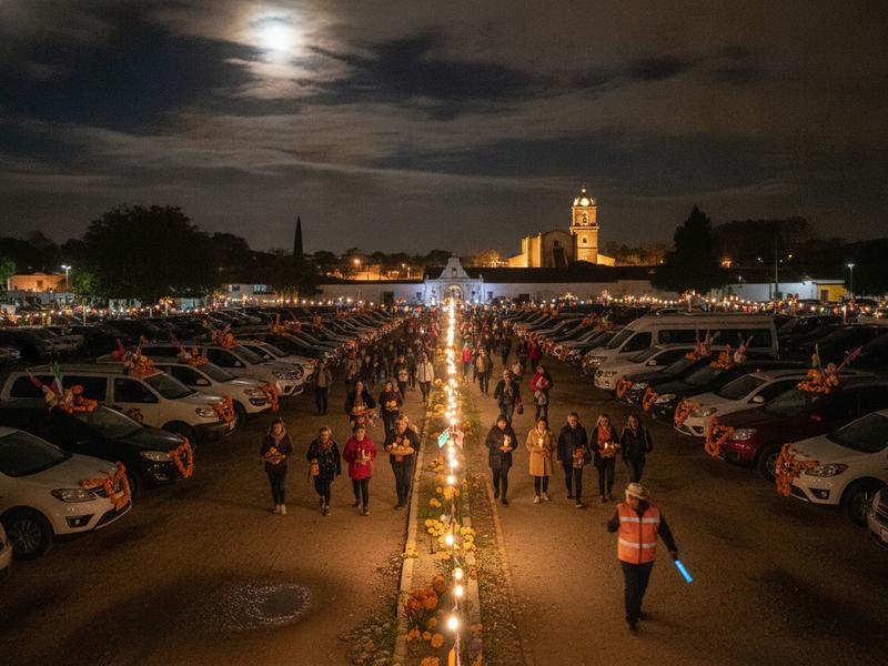 Travelers walking from an organized parking area toward Tzintzuntzan at night